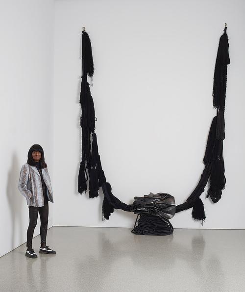 Barbara Chase-Riboud with “The Albino” (aka “All That Rises Must Converge/Black”), 1972, bronze with black patina, silk, wool, linen, and synthetic fibers, 138" x 137" x 30" / 350.5 x 348.0 x 76.2 cm
Michael Rosenfeld Gallery LLC, New York, NY. Ph...