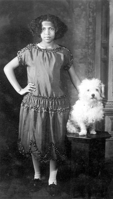 James Van Der Zee, "Young Girl with Dog," 1921. Gelatin silver print; printed c.1921, 4 3/4 x 2 3/4 inches ©Donna Mussenden Van Der Zee, Courtesy Howard Greenberg Gallery, New York