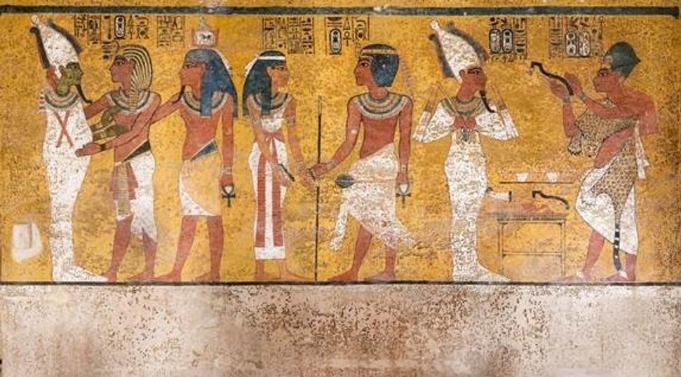 The north wall of the burial chamber depicts three separate scenes, ordered from right to left.  In the first, Ay, Tutankhamen’s successor, performs the “opening of the mouth” ceremony on Tutankhamen, who is depicted as Osiris, lord of the underworld.  In the middle scene, Tutankhamen, dressed in the costume of the living king, is welcomed into the realm of the gods by the goddess Nut.  On the left, Tutankhamen, followed by his ka (spirit twin), is embraced by Osiris.  